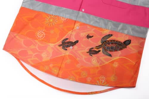 A Hawaiian shirt featuring vibrant orange fabric with turtle designs, complemented by a pink and grey collar.