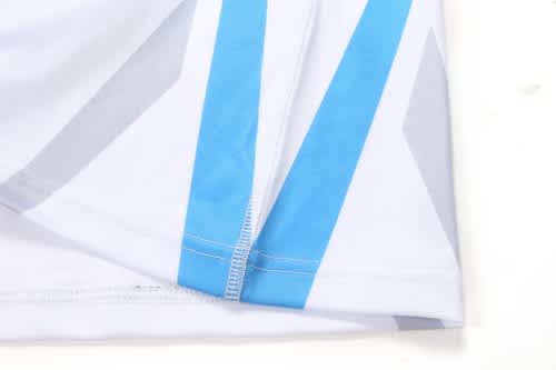 A sports uniform featuring a white base with blue and grey angular designs and a branded logo.