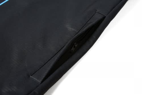 A black soft shell waistcoat featuring a zippered pocket and a logo.