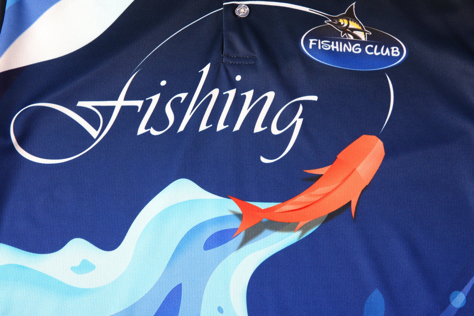 A blue sports jersey featuring a fish design, with a logo and the word "Fishing" prominently displayed.