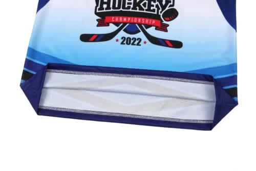 A blue ice hockey uniform jersey featuring a logo and striping detail at the hem.