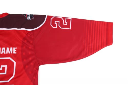 A red hockey jersey with a textured sleeve and a logo. The jersey features a number 2.