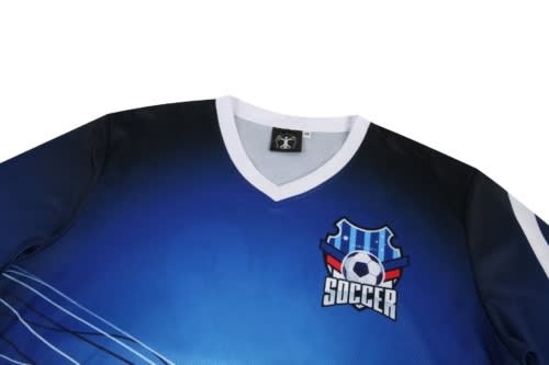 A blue and black soccer jersey featuring a logo with a football design. The shirt has a V-neck and is predominantly blue.