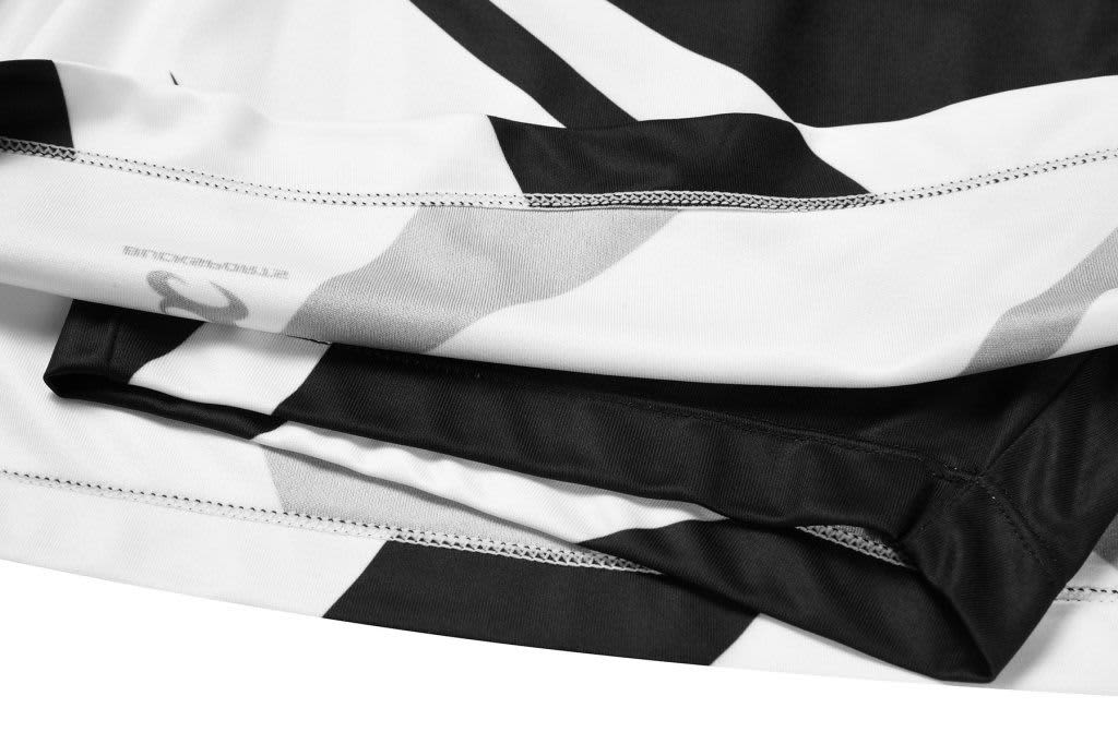 A close-up of a black and white bowling team uniform with a sleek design and a logo.