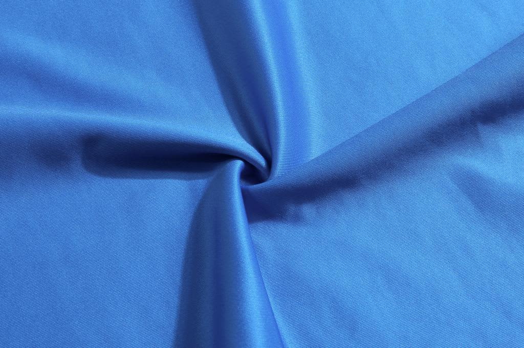 A blue fabric with a smooth texture, gathered in the centre, showcasing its soft and vibrant surface.