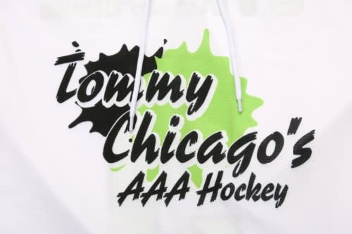 A white hoodie featuring a green and black logo with the text "Tommy Chicago's AAA Hockey" and a drawstring.