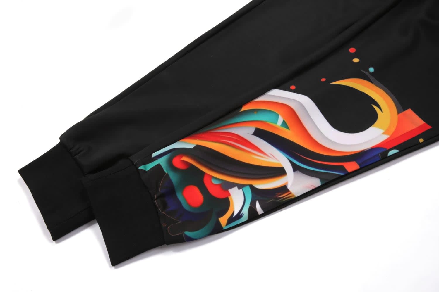 Black pants featuring a vibrant, abstract design in multiple colours along the sides and contrasting cuffs.