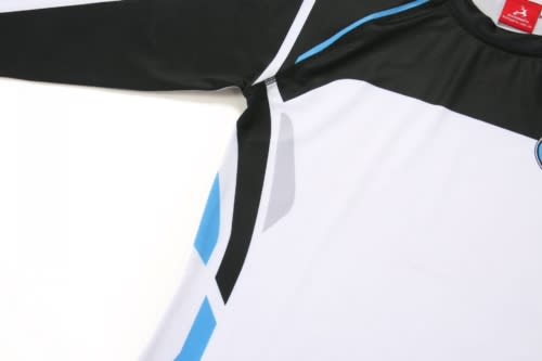 A sports uniform featuring a black, white, and blue design with long sleeves and a logo.
