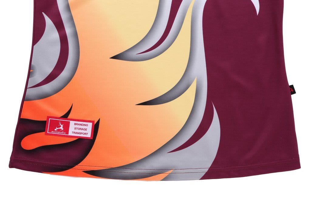 A maroon and orange women's polo shirt with a patterned design and a small branding label on the hem.