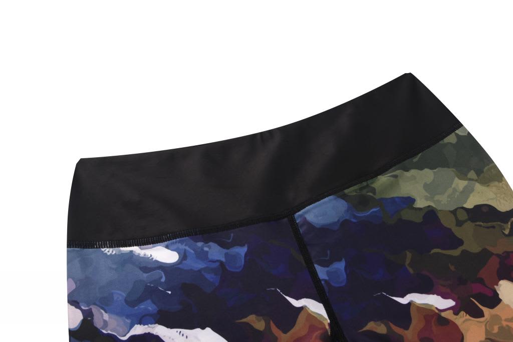 A pair of tight leggings featuring a multicoloured camouflage pattern with a black waistband.