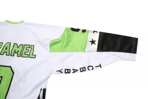A sports uniform featuring a white base with green and black accents, complete with a logo on the sleeve.