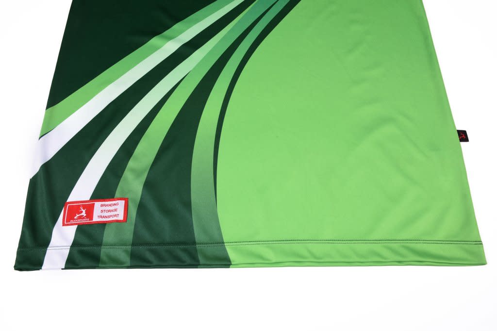 A green polo shirt featuring dynamic white and darker green designs, with a logo on the fabric.
