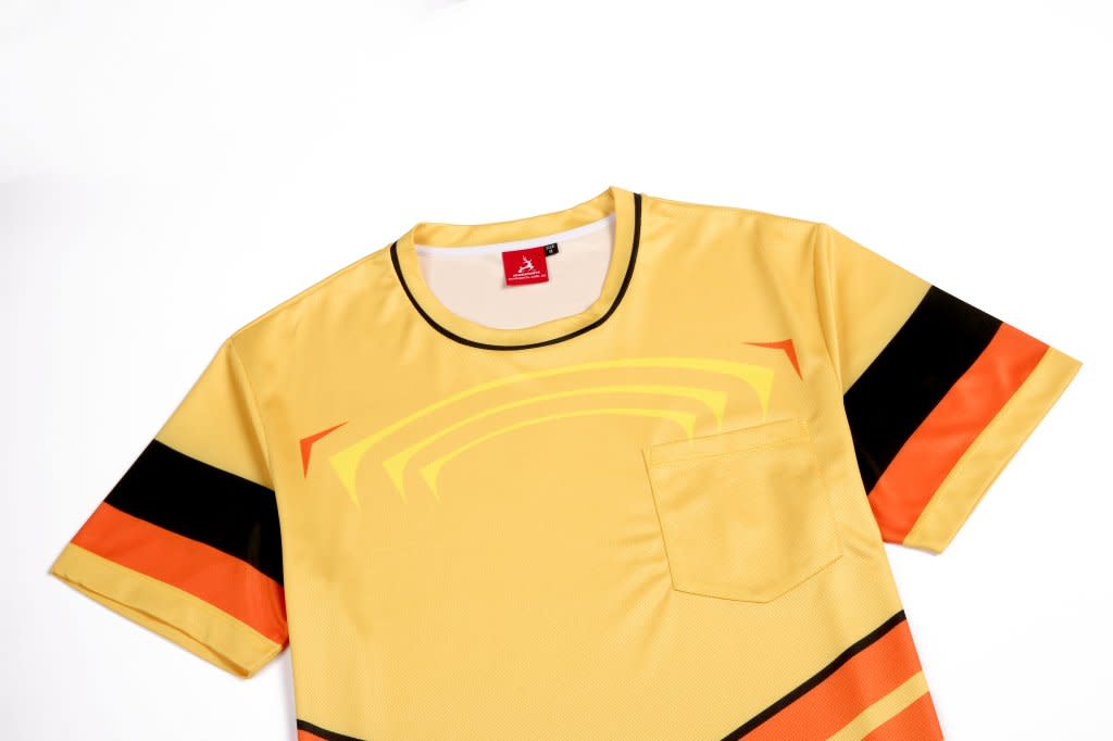 A yellow t-shirt with black and orange stripes, featuring a pocket and a logo.