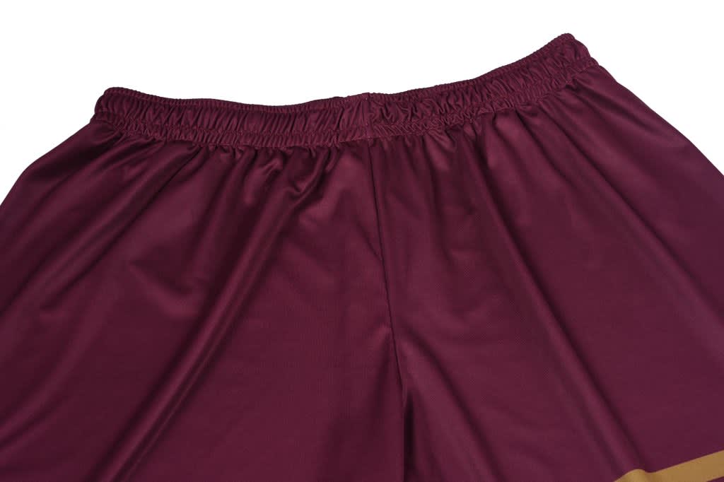 Maroon shorts featuring an elastic waistband and a golden trim at the bottom. Includes a logo on the waistband.