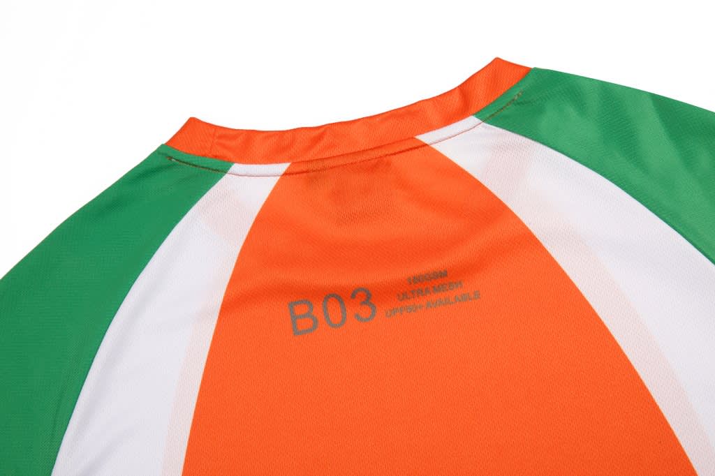 A 3/4 sleeve T-shirt featuring green, orange, and white panels, with a logo and text on the back.