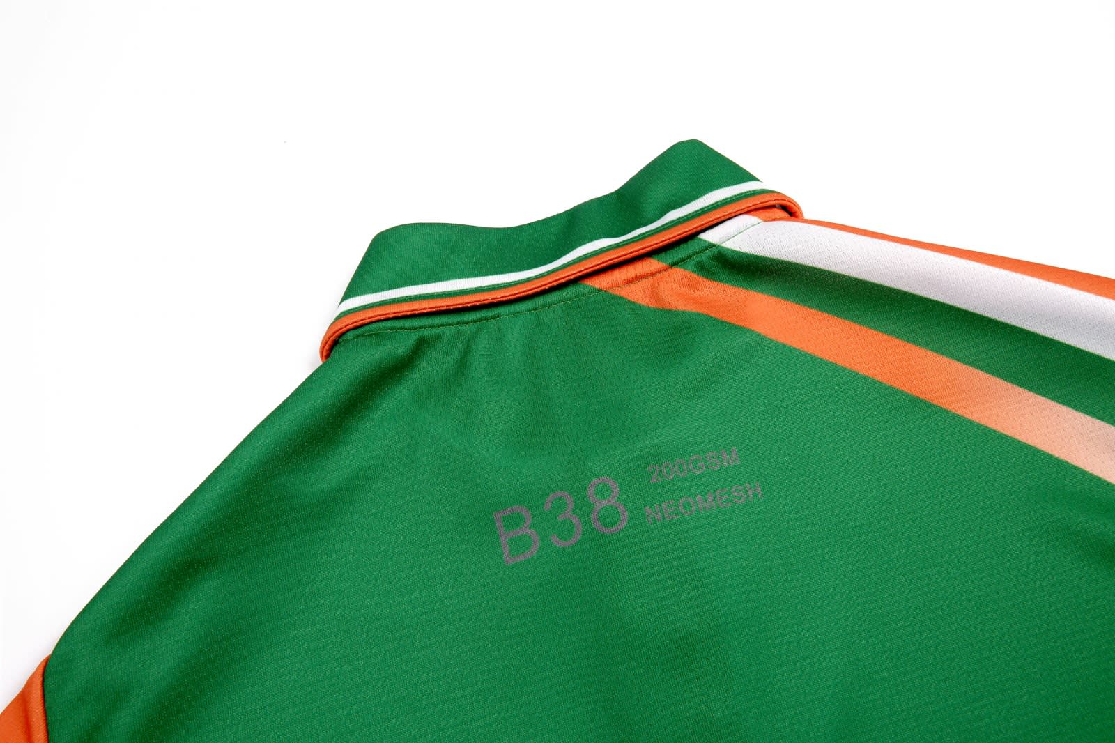 A polo shirt in green with orange and white stripes, featuring a collar and a logo on the back.