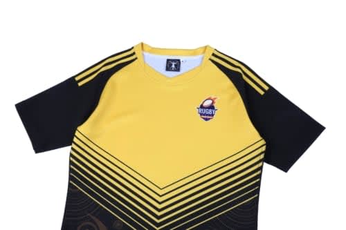 A yellow and black rugby jersey featuring a logo and a geometric design pattern on the front.
