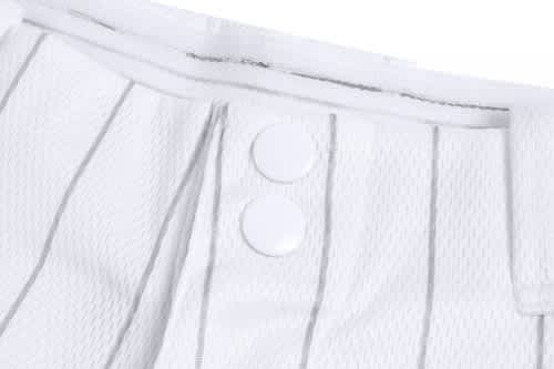A close-up of a white baseball uniform featuring vertical stripes, with two buttons visible at the waist.