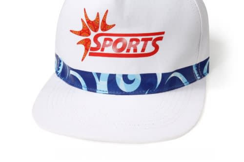 A sublimated sport cap in white with a blue patterned band and a logo on the front.
