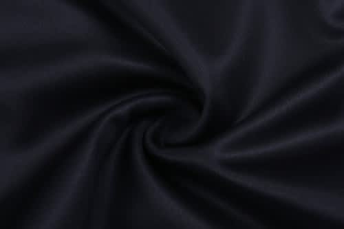 A close-up of black fabric with a smooth texture, showing a swirl pattern. It features a subtle sheen.