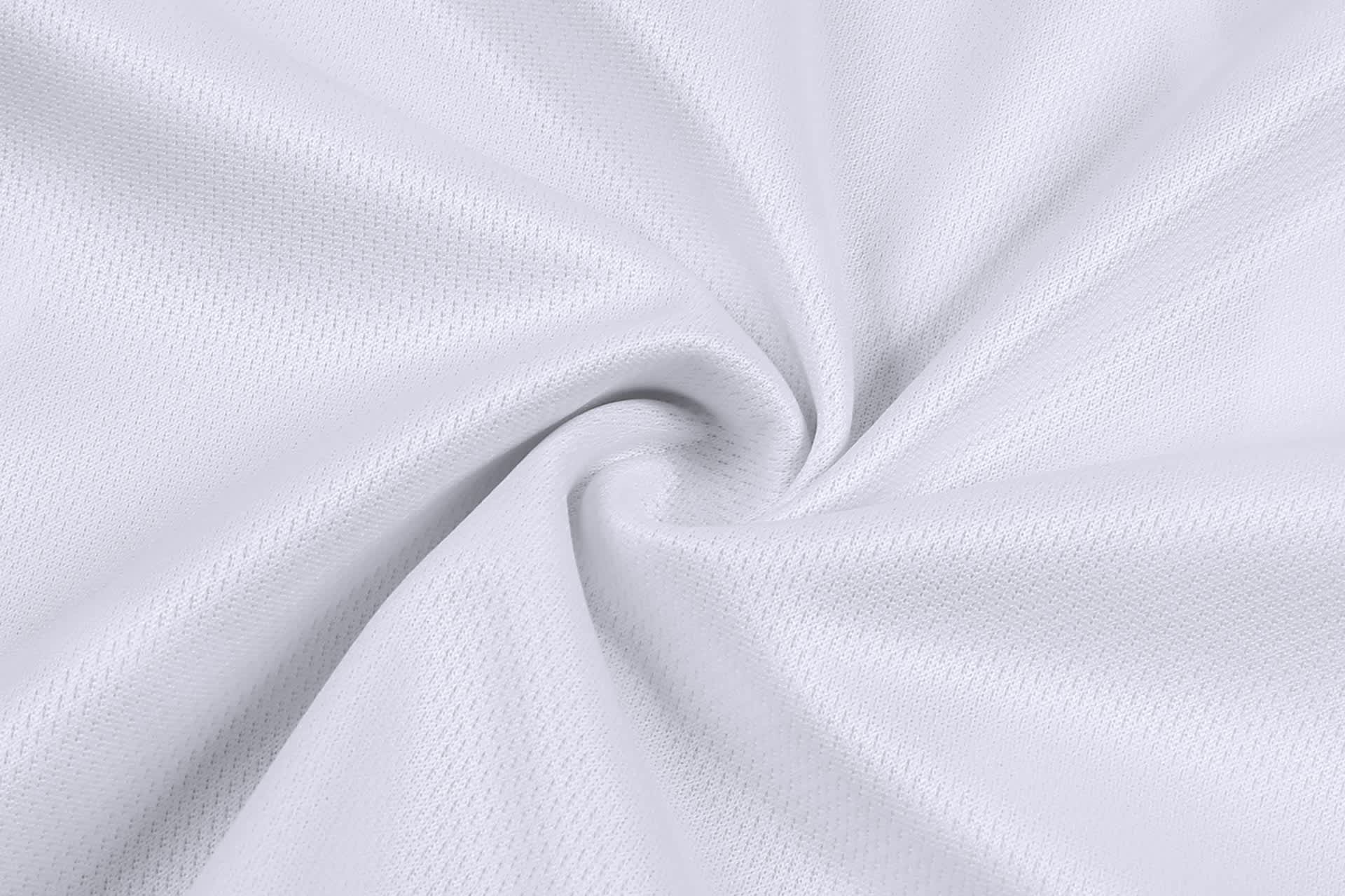 A close-up view of white mesh fabric, highlighting its textured pattern and soft drape.