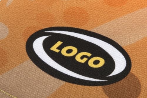 A close-up view of a fabric with an abstract orange pattern and a circular logo featuring bold text.