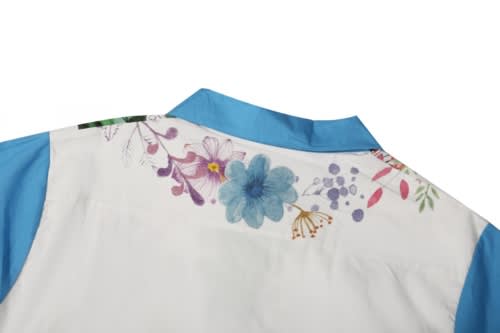 A beach shirt featuring a floral design on a white background with blue accents on the collar and sleeves.