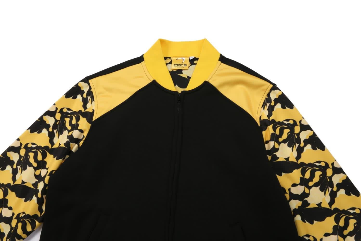 A black jacket with yellow and patterned sleeves, featuring a zip closure and a logo on the collar.