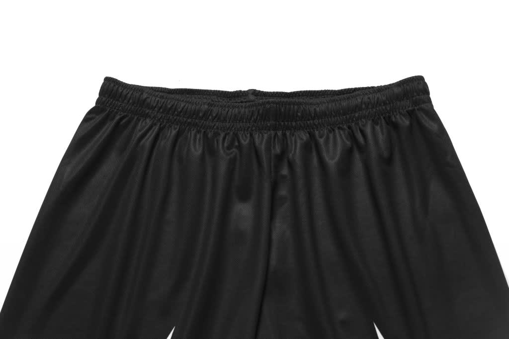 Black basketball shorts with an elastic waistband, featuring a logo at the top.