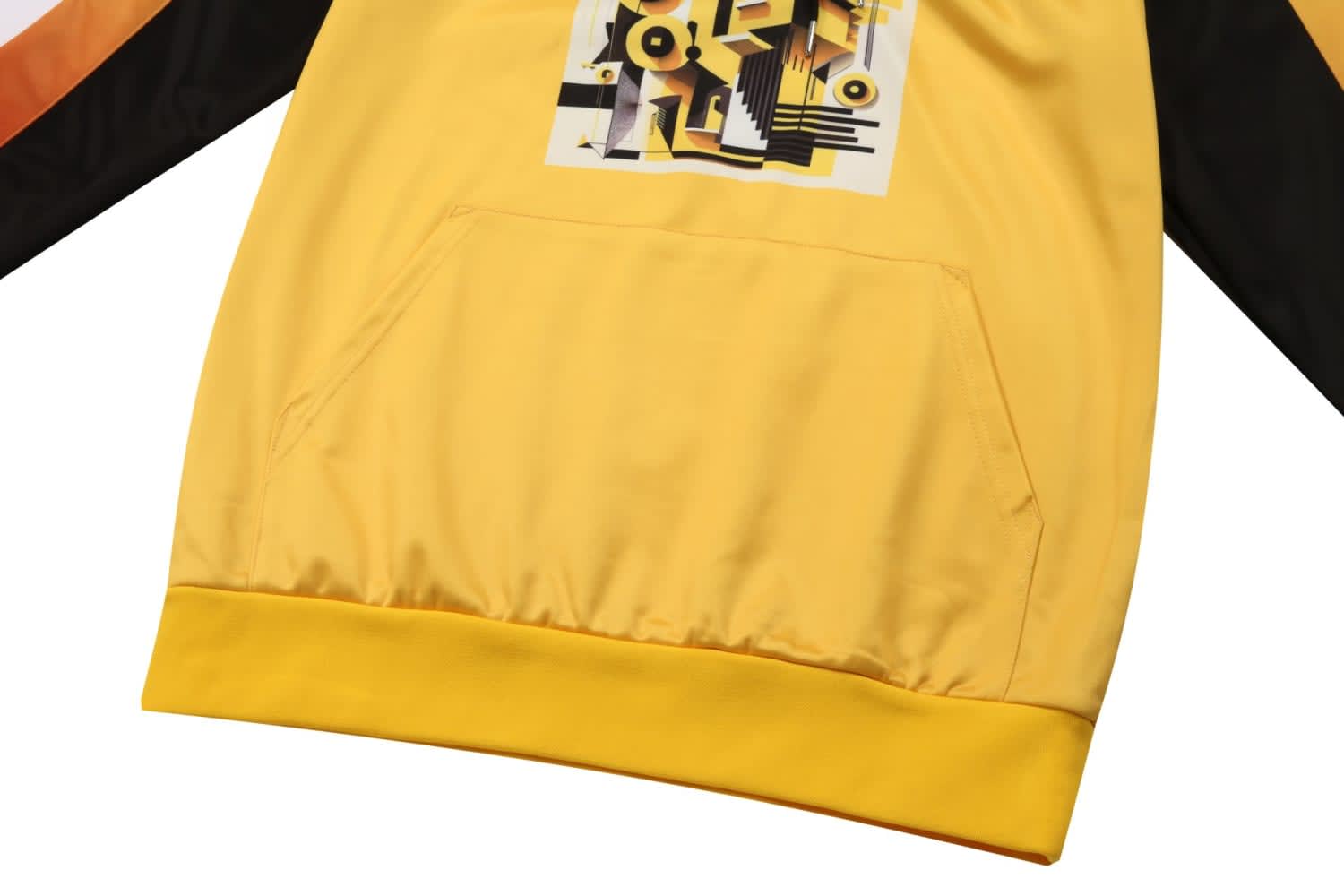 A yellow esport club jersey featuring a graphic design on the front and black and orange sleeves. It has a front pocket.