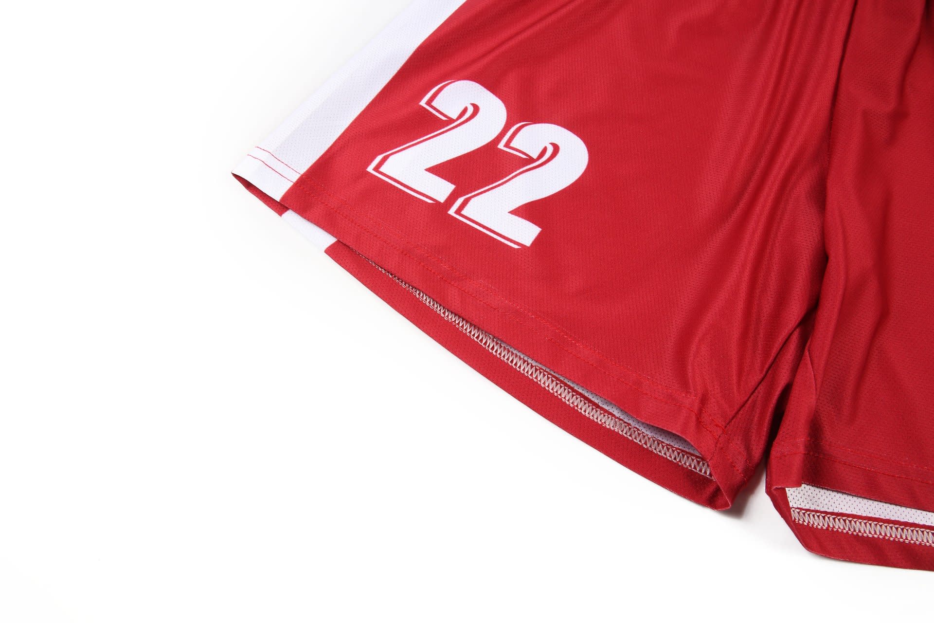 Red women's soccer uniform shorts featuring white accents and number '22' printed on the side.