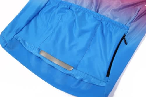 A blue sports jersey with a gradient design, featuring a back pocket and a small zippered compartment.
