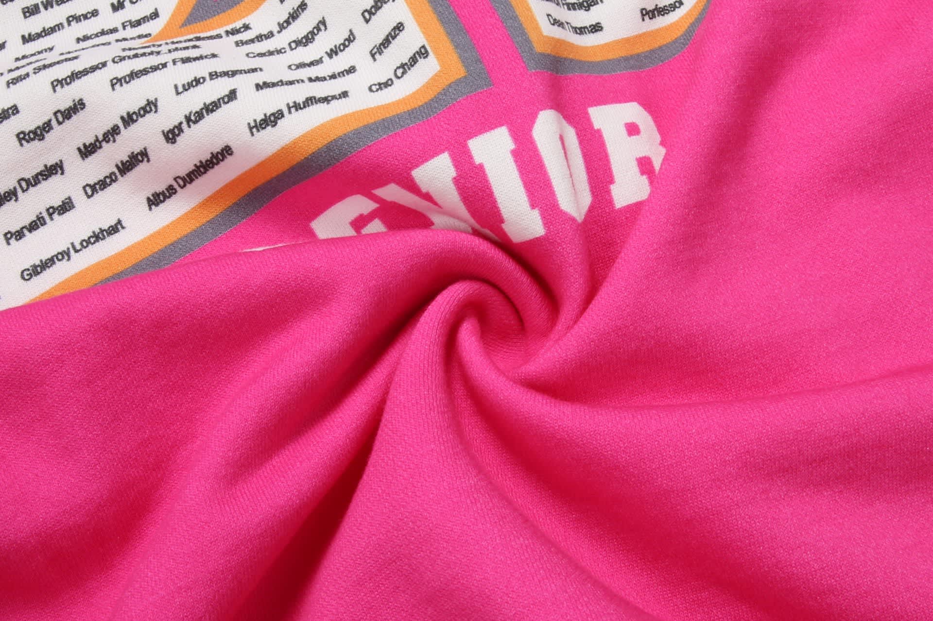 A pink cotton hoodie featuring direct printing with various names and a logo on the front.