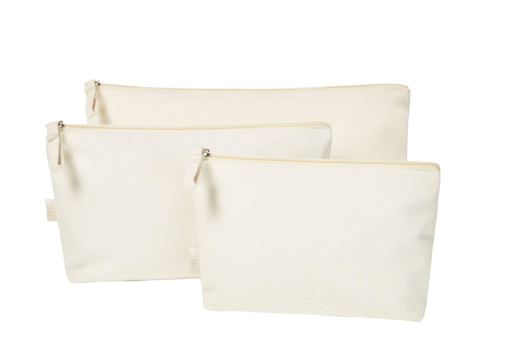 Three cream-coloured organic zipper bags in varying sizes, each featuring a zip closure and minimalist design.