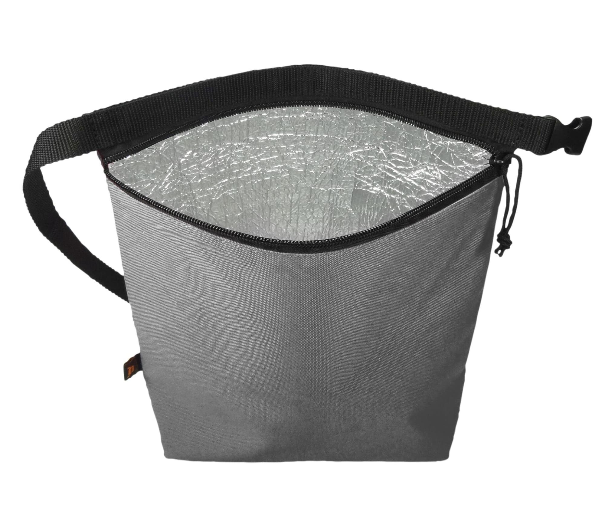 A grey cooler bag with a reflective interior, featuring a sturdy strap for easy carrying and a drawstring closure.