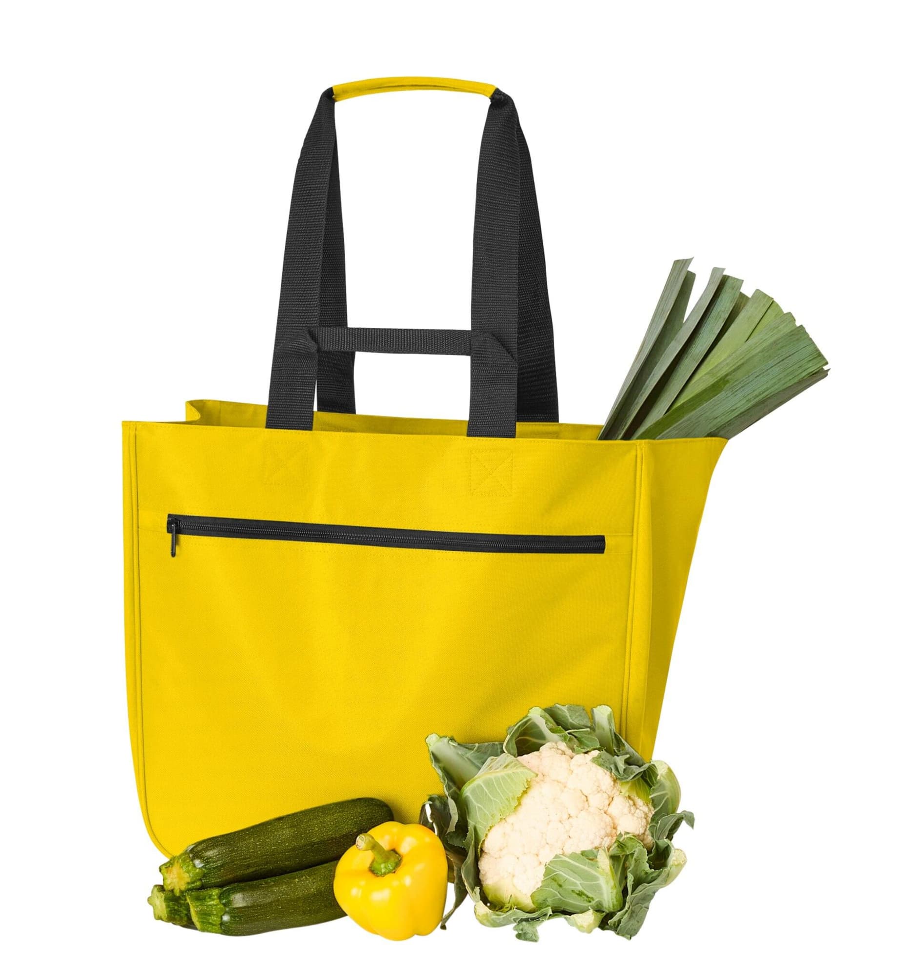 A bright yellow tote bag with black straps, alongside fresh vegetables including leeks, zucchini, cauliflower, and a yellow capsicum.