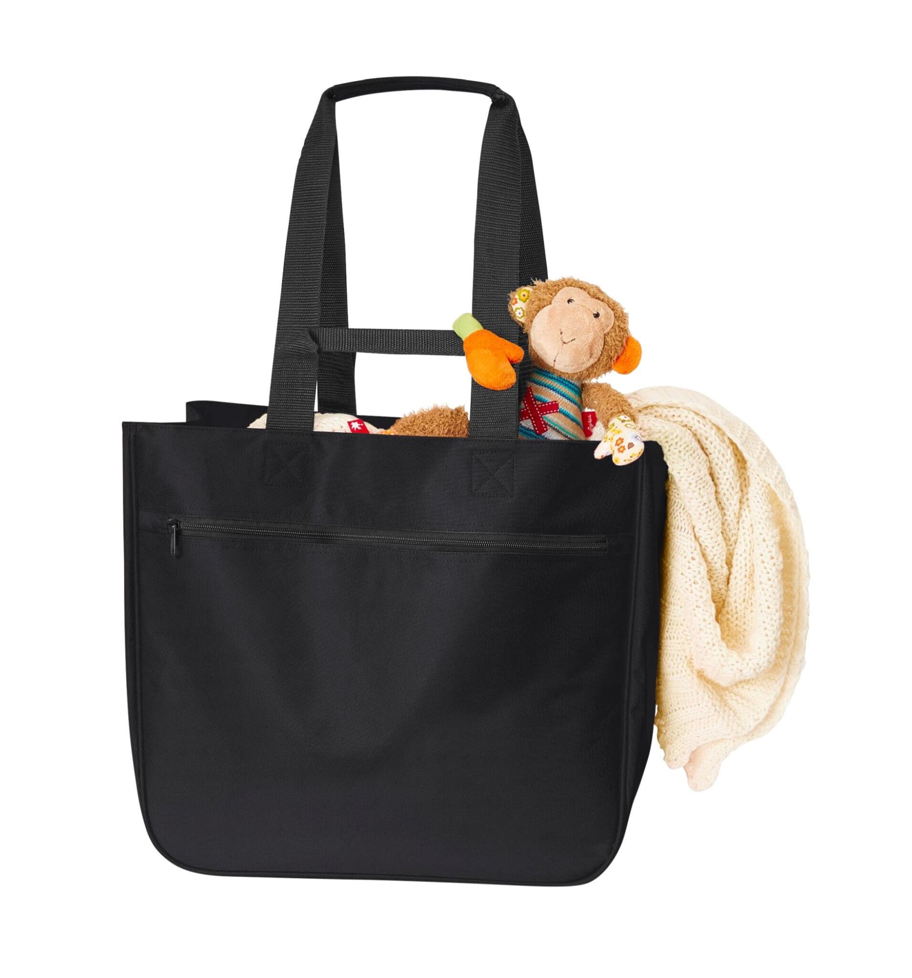 A black tote bag with long handles, featuring a stuffed monkey and a blanket peeking out. It has a logo on it.
