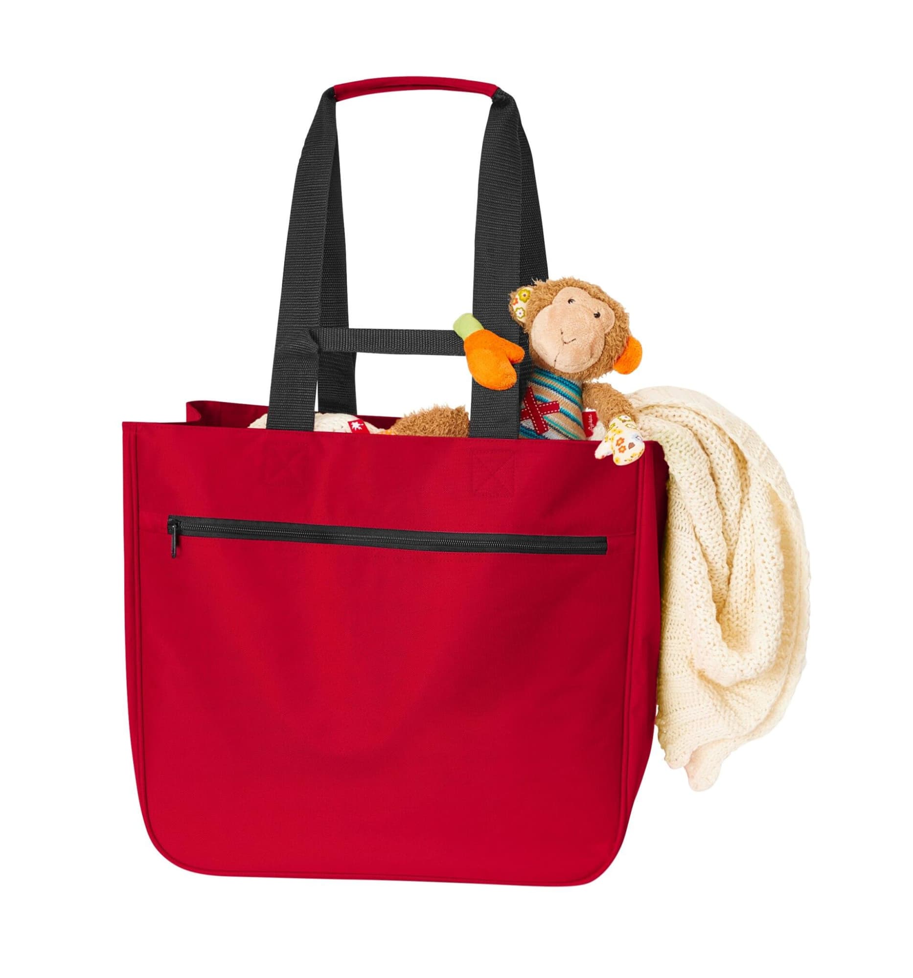 A red tote bag with black straps, featuring a toy monkey and a blanket peeking out from the top.