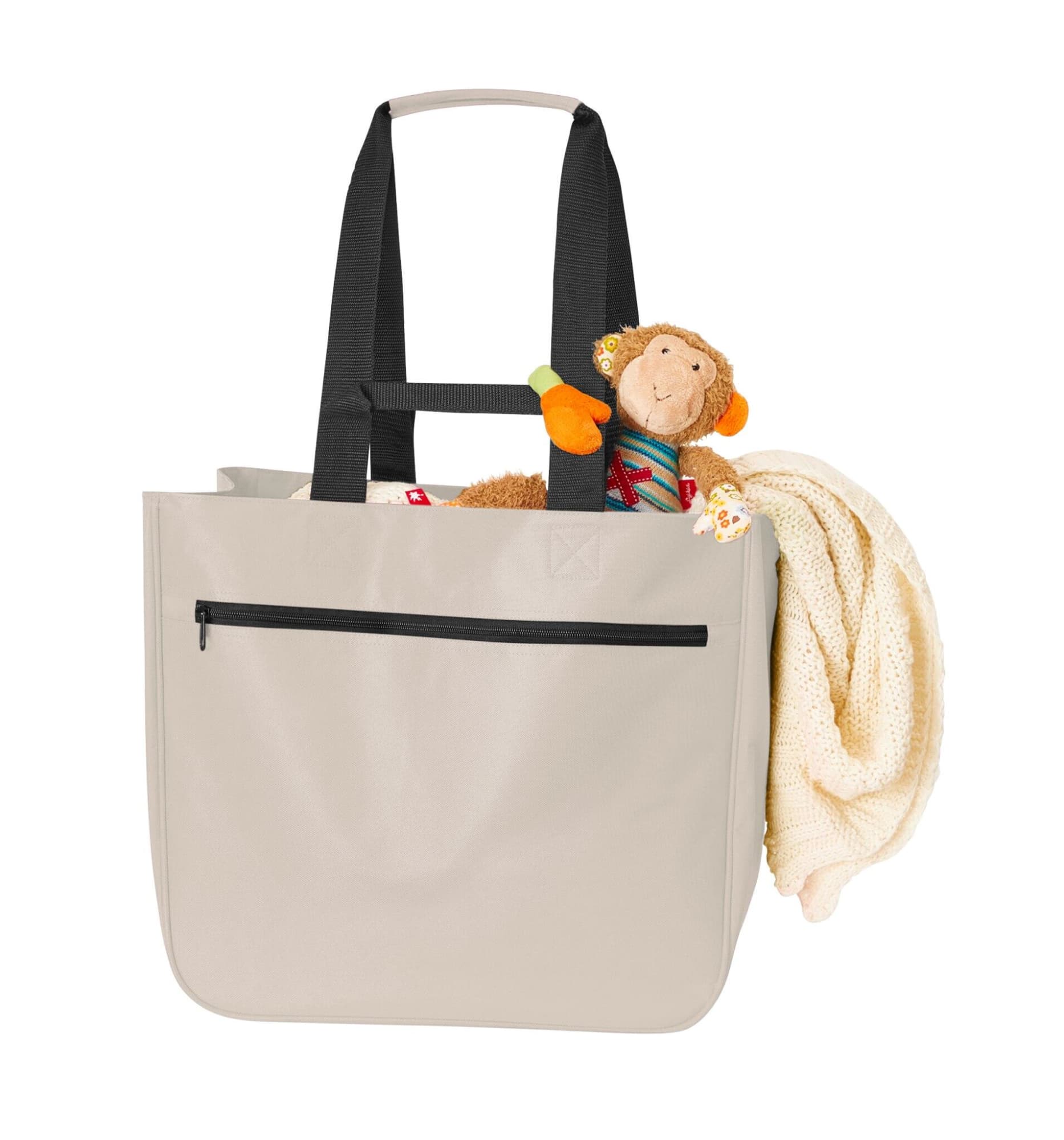 A soft beige bag with black straps, featuring a cuddly toy monkey and a blanket peeking out. It has a zipper pocket.