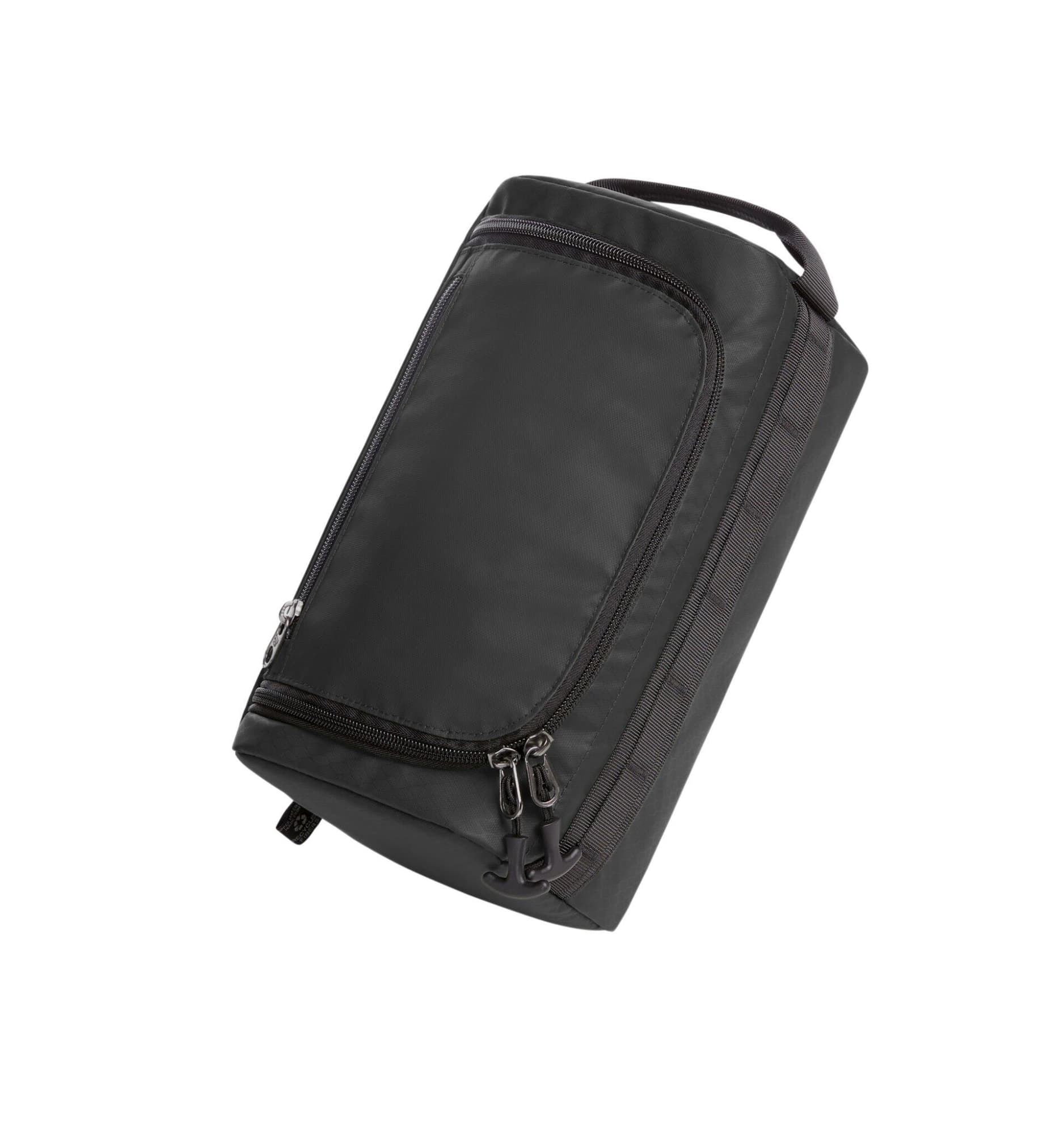 A black toiletry bag featuring a zippered compartment and a handle, with a branding logo on the side.
