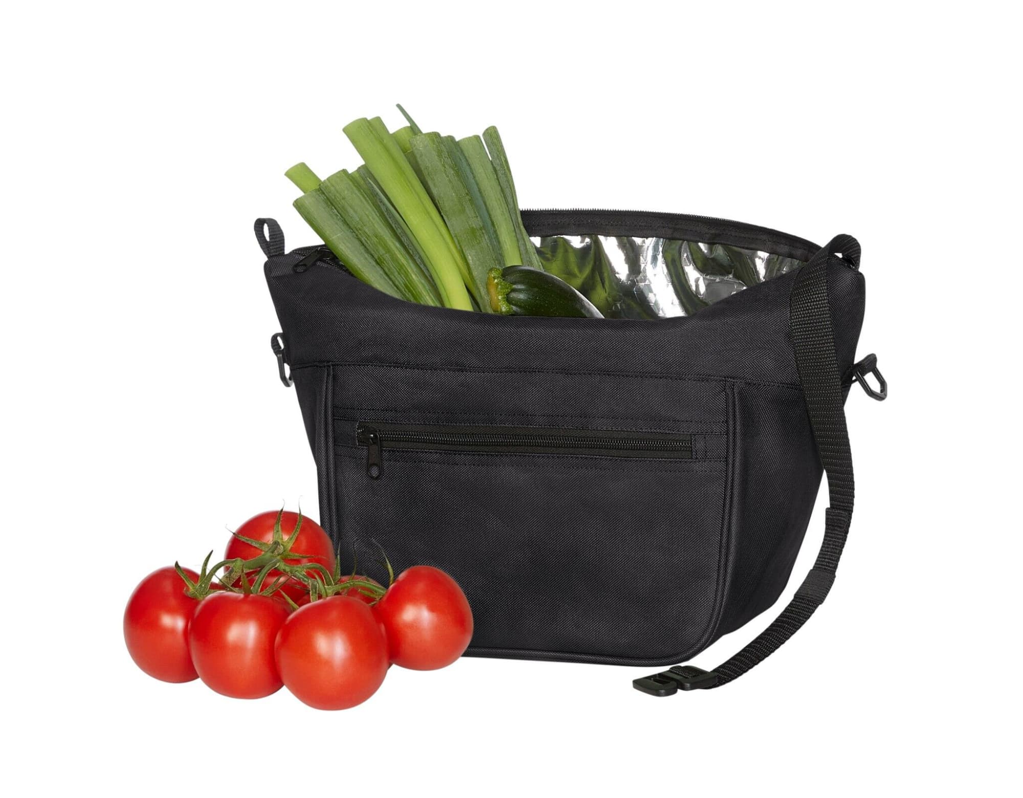 A black Softbasket Lunchbag with green leeks and zucchini inside, alongside fresh red tomatoes. Features a logo.