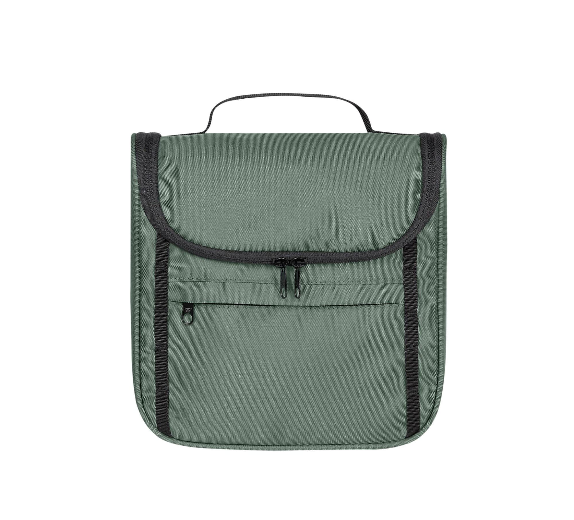 A green toiletry bag with a flap closure, featuring a front zip pocket and a carry handle on top.