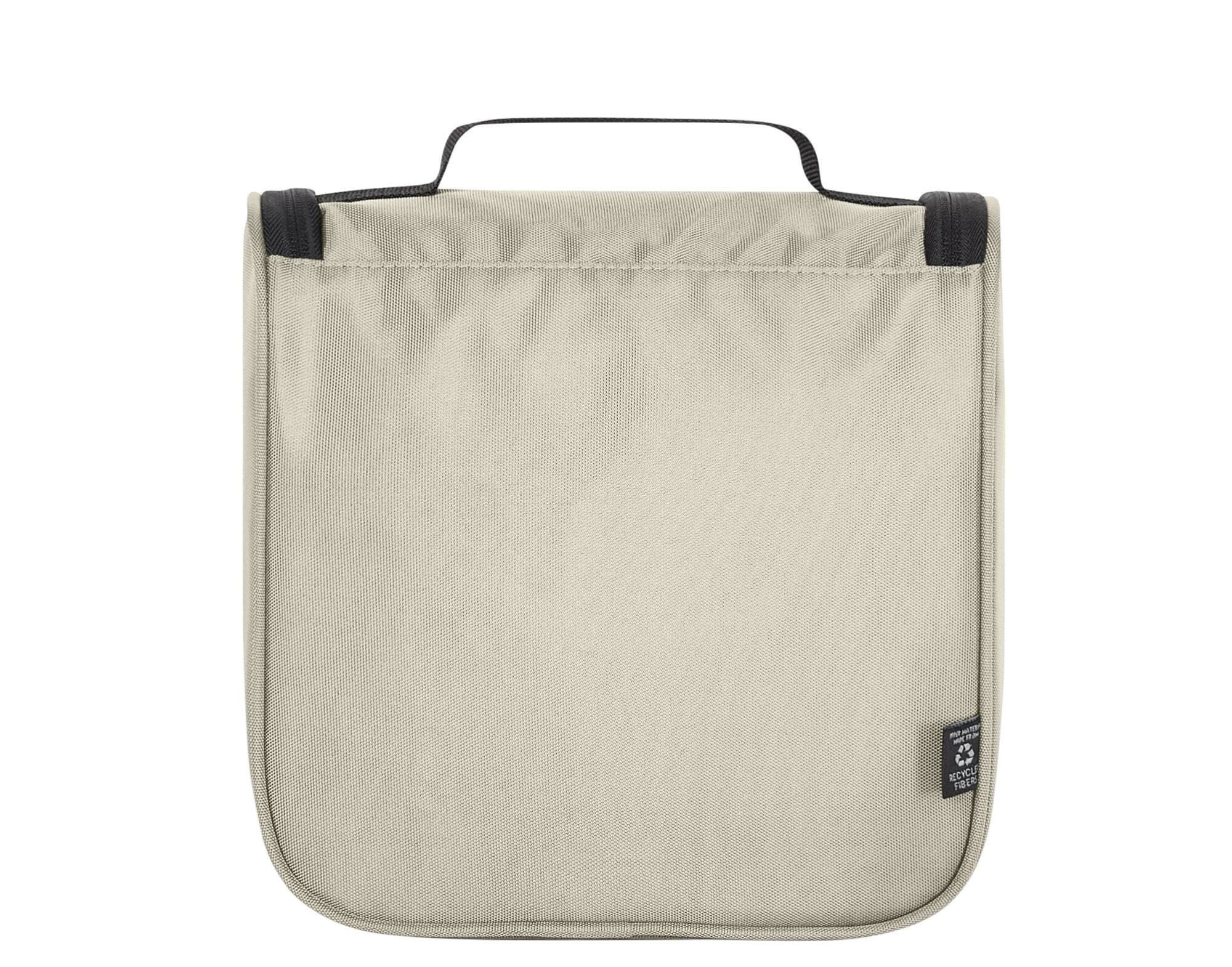 A cream toiletry bag with a black handle, featuring a simple design and a branded label.