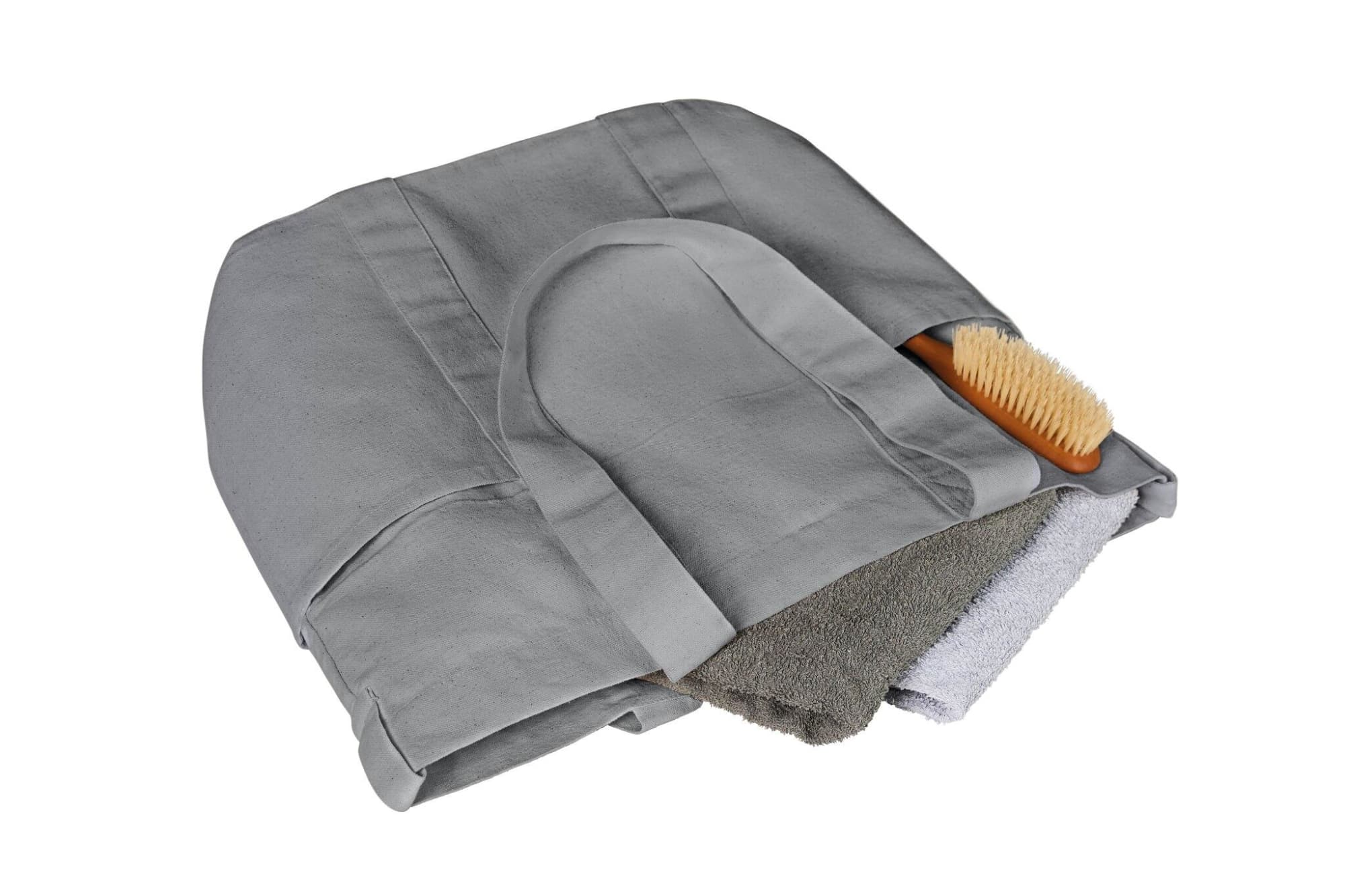 A grey tote bag featuring two towels and a wooden brush inside. The bag has a logo on its surface.