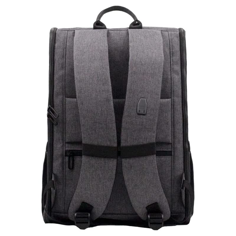 A grey backpack with padded straps and a top handle, featuring zippers and a logo on the front.