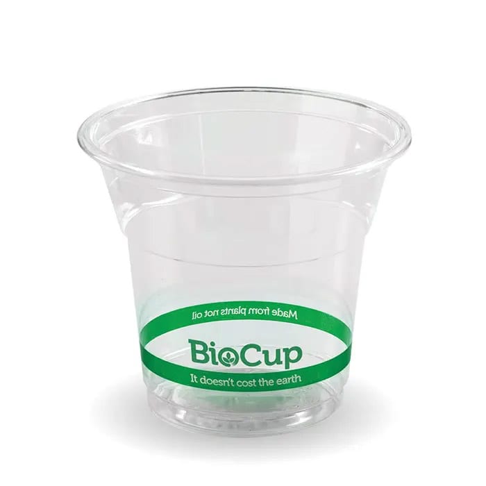 A clear, disposable plastic cup with a green band and branding. Suitable for beverages or snacks.