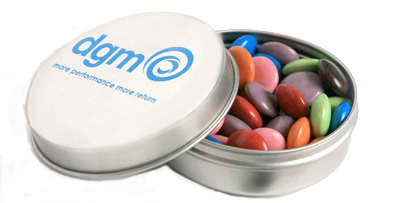 A silver tin containing colourful chocolate beans, featuring a simple logo on the lid.