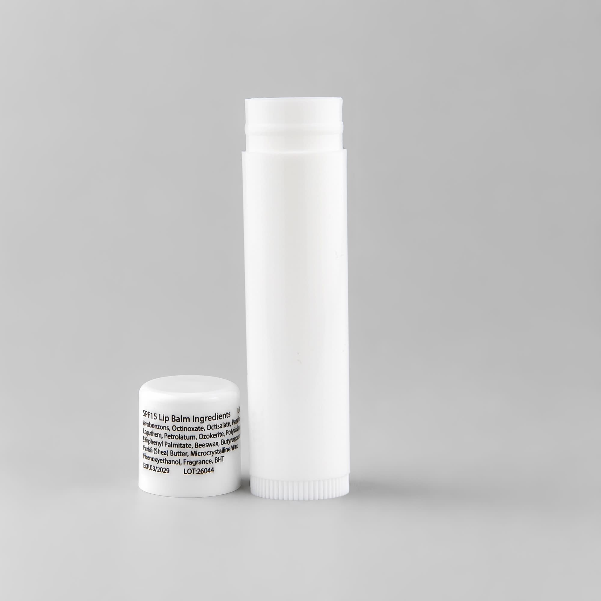 A white lip balm container and a small white cap, featuring an unobtrusive logo.