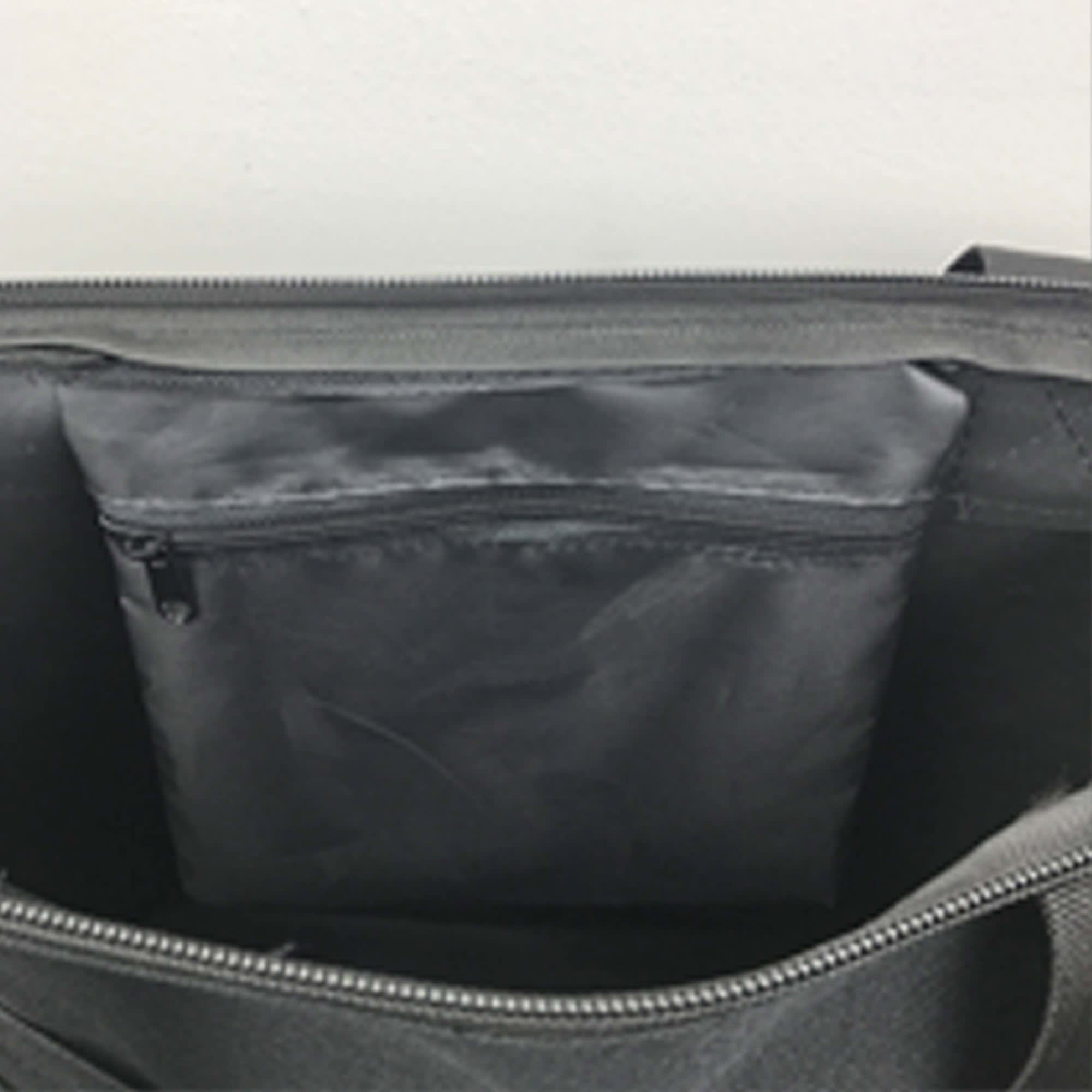 A grey nylon tote bag with a zipped interior pocket and a spacious main compartment.