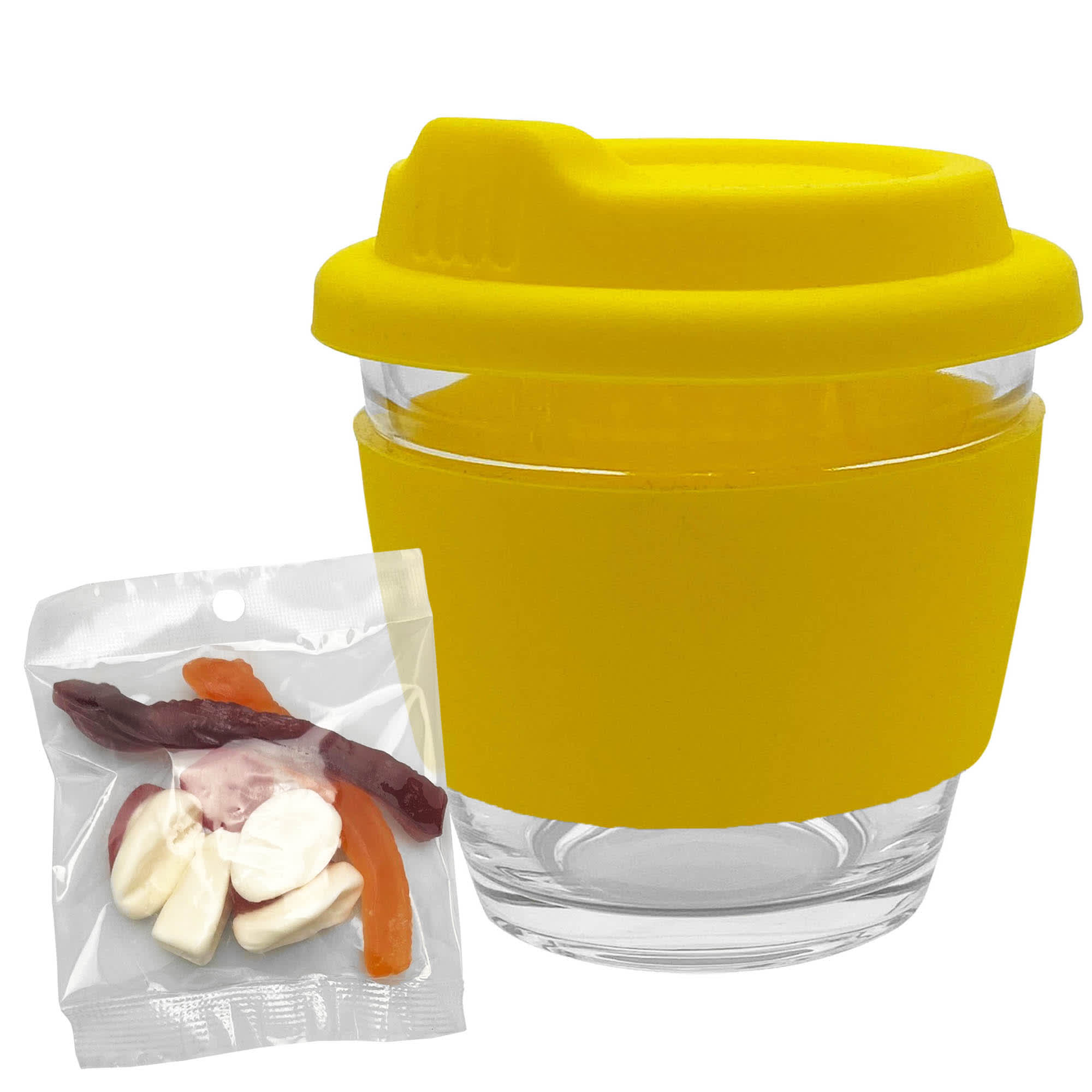 A clear glass coffee cup with a yellow silicone lid and sleeve, accompanied by a bag of mixed lollies.